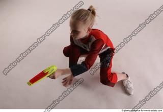 DENISA SITTING POSE WITH GUN